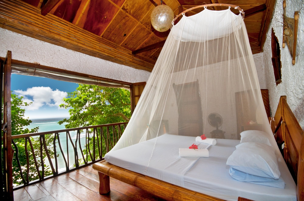 Canopy resort bed overlooking the beach