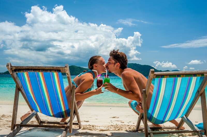 Kissing couple with tropical drinks