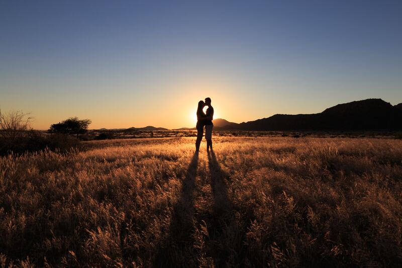 Couple silhouetted by the sunset